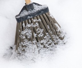 Broom on the snow in winter