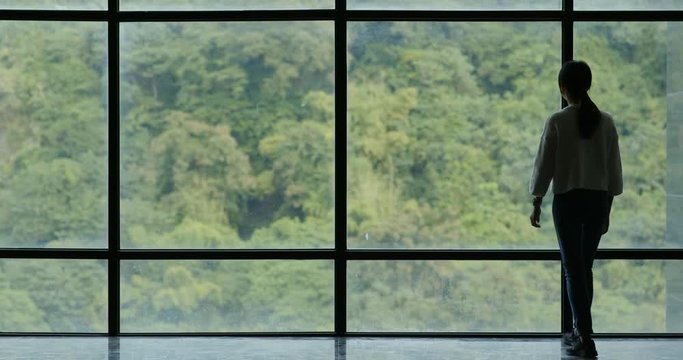 Businesswoman walking over the glass window