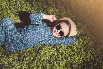 Cute girl in hat with dandelion. Spring mood.

