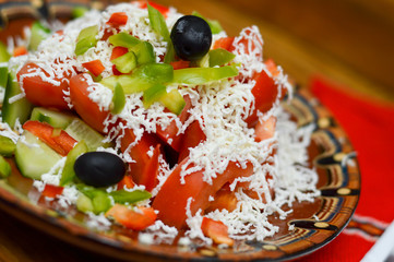 Picture of a traditional Bulgarian salad prepared from tomatoes, cucumbers, pepper and cheese.Shopska salad.