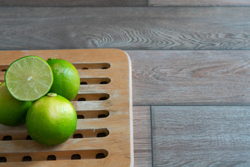Limes on a wooden tray in the kitchen