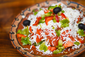 Picture of a traditional Bulgarian salad prepared from tomatoes, cucumbers, pepper and...