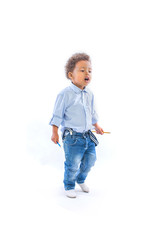 Black child with pencils in his hands looks away from him on an isolated background