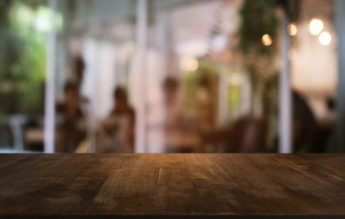 Empty dark wooden table in front of abstract blurred bokeh background of restaurant . can be used for display or montage your products.Mock up for space.