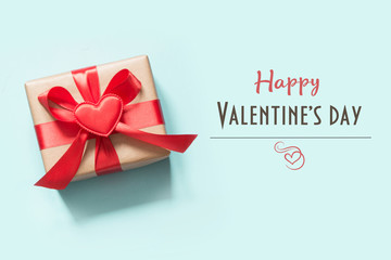 Valentine's card. Gift with heart on blue. Top view.