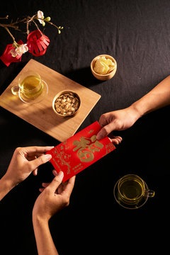 Chinese Lunar New Year concept red envelope with Chinese character means happiness or good fortune, the chinese sentence means “Wishing you prosperity” and “May all your wishes come true”.