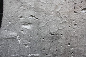 Vintage surface of old shabby wall with falling off plaster, beige-brown shades, background, texture