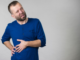 Man having stomach or ribs pain ache.