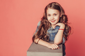 Close up portrait of fashionable teen girl on pink background