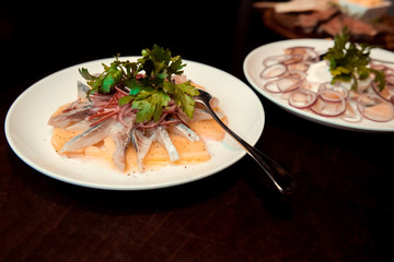 Plate of herring with oil and onion, greek style food.