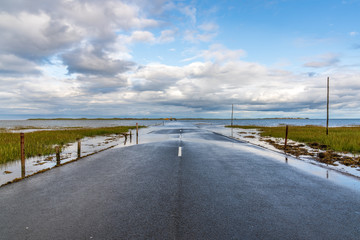 Flooded Road between Beal and the Holy Island of Lindisfarne in Northumberland, England, UK