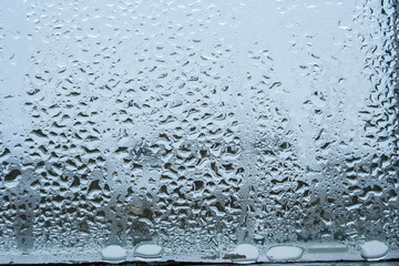 steamy glass. window covered with drops of water vapor