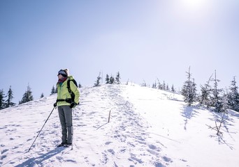 Fototapeta na wymiar Tourist looking on winter mountains