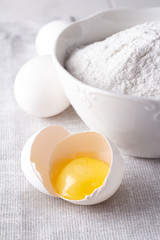 flour and raw chicken eggs closeup.