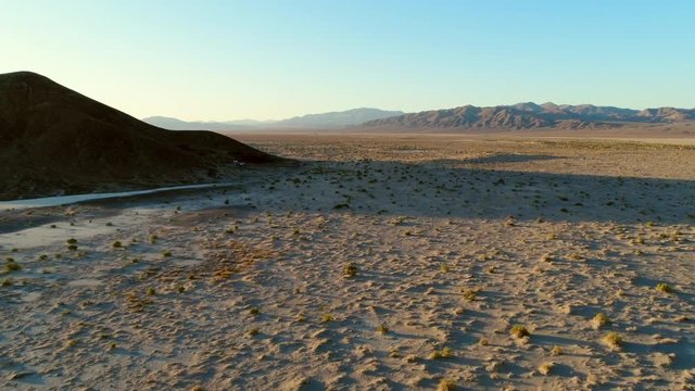Aerial Pan Left To Right: Lone Mountain in Middle of Desert in USA