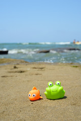 Fototapeta na wymiar fish and crab toys on sand