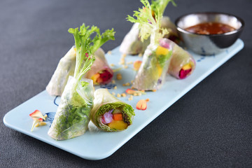 Delicate spring rolls in a blue dish