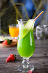 Fresh green apple juice in a transparent glass