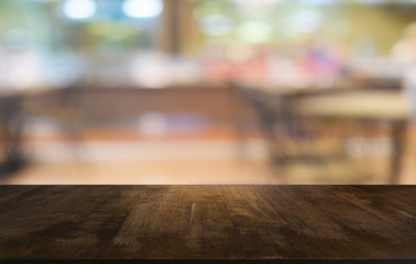 Empty dark wooden table in front of abstract blurred bokeh background of restaurant . can be used for display or montage your products.Mock up for space.