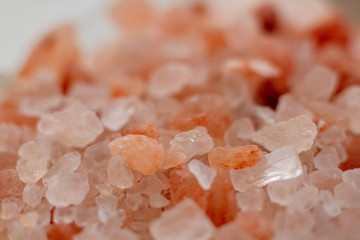 Fototapeta na wymiar Macro photo of pink Himalayan salt. Crystals of mineral salt pink. A lot of organic mineral salt macro. Selective focus.