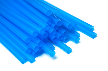 closeup of blue plastic straw collection on white background