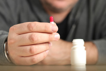 Man takes the antibiotic capsule