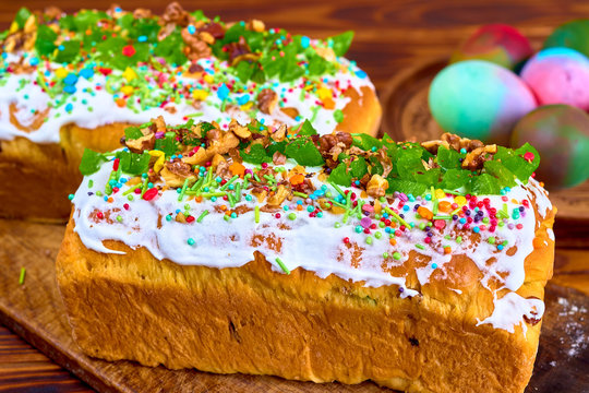 Easter sweet bread Orthodox kulich, paska. Two rectangular cake decorated with white frosting and candy sprinkles with painted colorful Easter eggs