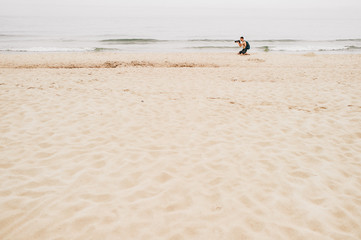 Alone traveler holding a camera , holiday on the beach