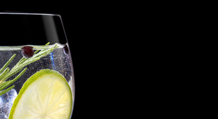 Close up of gin tonic glass on black background