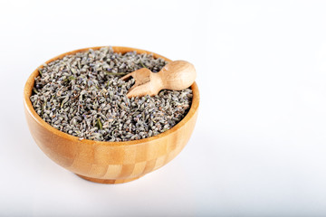Dried lavender flowers in wooden bowl on white background