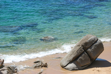 Fototapeta na wymiar High angle view of Natural splashing wave sea stone beach on sunny day at Phuket island.