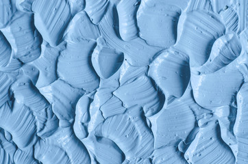 Obraz premium Blue cambrian cosmetic clay (facial mask, cream, body scrub) texture close up. Abstract background with brush strokes.