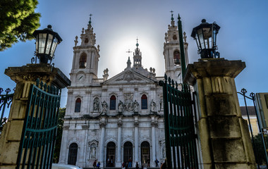 Fototapeta na wymiar View to the Basilica da Estrela framed by the gates of Jardim da Estrela, Lapa - Portugal