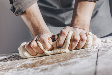Chef making and kneading fresh dough