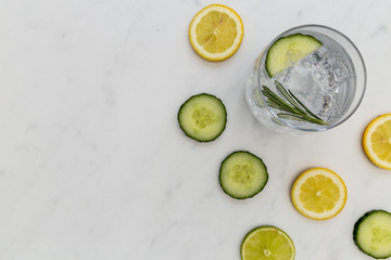 Gin tonic cocktail drink glass with ice cucumber lime lemon white background