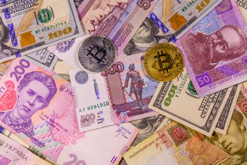 Fototapeta na wymiar Bitcoin coins on the american, ukrainian and russian banknotes