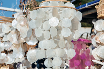 A closeup of a seashell decoration for hanging different colors.