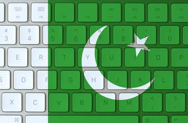 Pakistan flag and computer keyboard in the background