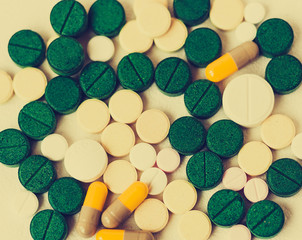 Medicine green, pink and yellow pills or capsules on white background with copy space. Drug prescription for treatment medication. Blister pack.