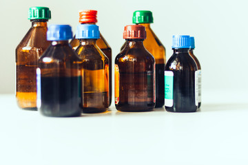 Medicine bottles on white background with copy scape for text, retro concept closeup.