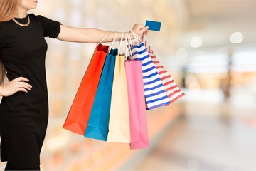 Close up woman hand with many shopping bags and credit card