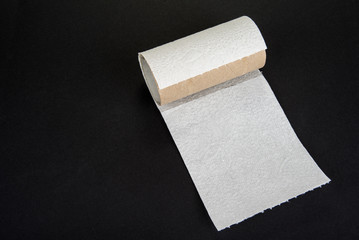Empty toilet paper roll on a black background.Bad luck concept