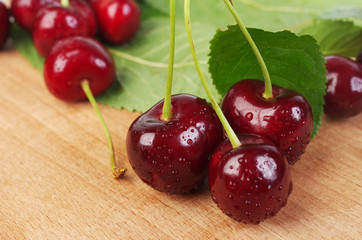 Ripe sweet cherry on a wooden table. Close-up