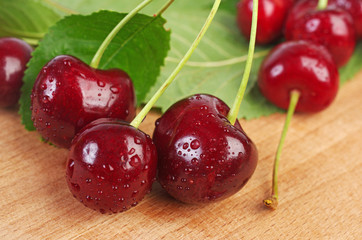 Ripe sweet cherry on a wooden table. Close-up