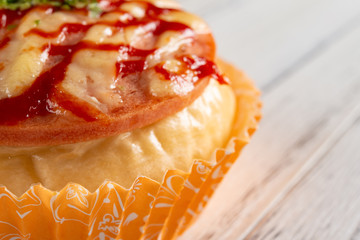 bread with BBQ pork on top on white wood background with  copy space