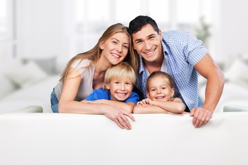 Beautiful smiling family in room on couch