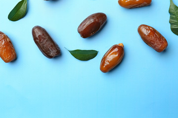 Sweet dried dates on color background