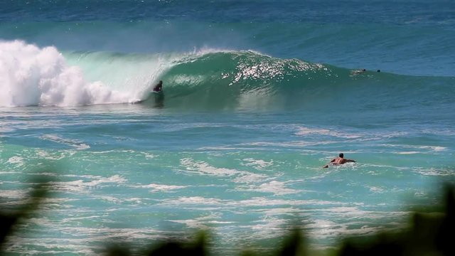 Blue Ocean in Hawaii with Bodyboarder Catching a Wave & Surfer Paddling Out