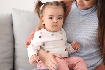 Young woman with her cute little daughter at home