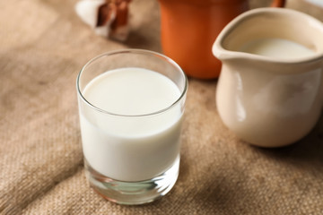 Glass of fresh milk on table